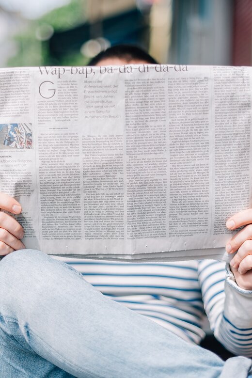 Person reading newspaper